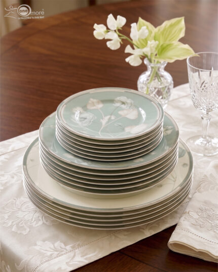 A luxury super bone china dinner set with delicate blue floral patterns and gold accents, including plates, bowls, and a tea service set on a marble surface.