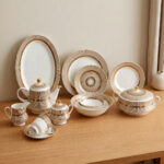 A luxury super bone china dinner set featuring a white base with gold-toned textured borders and metallic accents, displayed on a wooden table in 7.jpg.