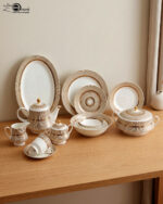 A luxury super bone china dinner set featuring a white base with gold-toned textured borders and metallic accents, displayed on a wooden table in 7.jpg.