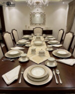 A luxury super bone china dinner set featuring a white base with gold-toned textured borders and metallic accents, displayed on a wooden table in 7.jpg.