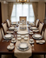A luxurious super bone china dinner set from Onemore Crockery featuring a grey floral design and gold accents, including plates, bowls, a teapot, and serving dishes arranged on a wooden surface as seen in 7.jpg.