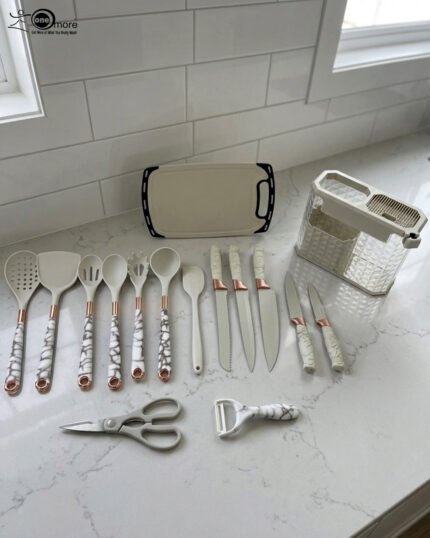 A comprehensive 16-piece kitchen tool set featuring cream-colored silicone utensils with marble-patterned handles, rose gold accents, a matching knife set, kitchen shears, a peeler, and a cutting board, all stored in a clear geometric organizer.