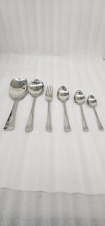 Professional studio photography showing the high-quality finish of the 53-piece stainless steel cutlery set arranged on a wooden surface, as displayed in 8.jpg.