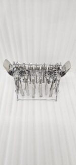 A complete 37-piece stainless steel cutlery set, including various spoons, forks, and knives with decorative handles, displayed on a linen tablecloth as shown in 7.jpg.