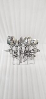 The image 6.jpg displays a selection of items from a 37-piece stainless steel cutlery set, neatly arranged on a wooden background, showcasing the sleek design and finish of the spoons, forks, and serving utensils.