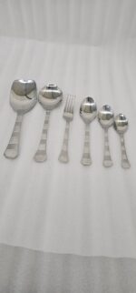 The premium 53-piece stainless steel cutlery collection featured in 6.jpg, displayed neatly on a wooden table to highlight the polished finish and design.