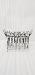 A complete 37-piece stainless steel cutlery set, including various spoons, forks, and knives with decorative handles, displayed on a linen tablecloth as shown in 7.jpg.