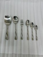 A high-quality 53-piece stainless steel cutlery set featuring elegant patterned handles, displayed on a grey fabric surface as shown in 9.jpg.