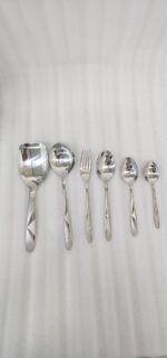 6.jpg displays an elegant 37-piece stainless steel cutlery set, featuring an assortment of tablespoons, teaspoons, forks, knives, and serving utensils arranged neatly on a wooden background to showcase the sophisticated design and finish.