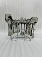 A complete 53-piece stainless steel dining cutlery set featuring spoons, forks, knives, and a serving stand displayed elegantly on a wooden background, as featured in 8.jpg.