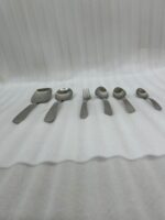 A complete 53-piece stainless steel cutlery set featuring various spoons, forks, and knives displayed on a wooden surface in 6.jpg, showcasing the polished finish and modern design.