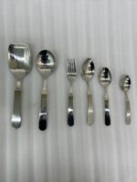 A complete 53-piece stainless steel cutlery set featuring various spoons, forks, and knives displayed on a wooden surface in 6.jpg, showcasing the polished finish and modern design.