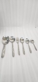 6.jpg displays an elegant 37-piece stainless steel cutlery set, featuring an assortment of tablespoons, teaspoons, forks, knives, and serving utensils arranged neatly on a wooden background to showcase the sophisticated design and finish.