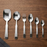 A complete 53-piece stainless steel cutlery set featuring various spoons, forks, and knives displayed on a wooden surface in 6.jpg, showcasing the polished finish and modern design.
