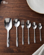 6.jpg displays an elegant 37-piece stainless steel cutlery set, featuring an assortment of tablespoons, teaspoons, forks, knives, and serving utensils arranged neatly on a wooden background to showcase the sophisticated design and finish.