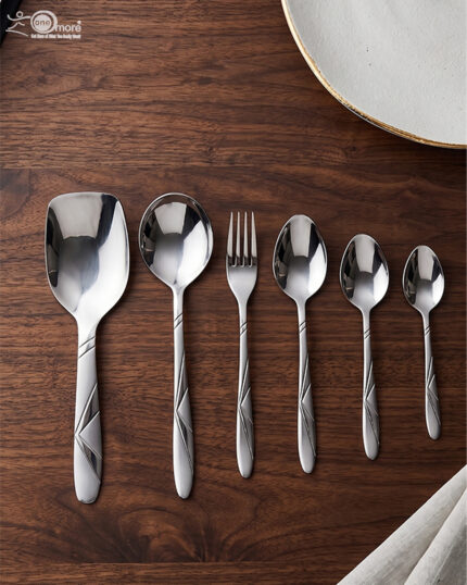 6.jpg displays an elegant 37-piece stainless steel cutlery set, featuring an assortment of tablespoons, teaspoons, forks, knives, and serving utensils arranged neatly on a wooden background to showcase the sophisticated design and finish.