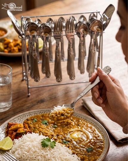 A complete 37-piece stainless steel cutlery set, including various spoons, forks, and knives with decorative handles, displayed on a linen tablecloth as shown in 7.jpg.