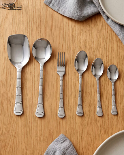 The image 6.jpg displays a selection of items from a 37-piece stainless steel cutlery set, neatly arranged on a wooden background, showcasing the sleek design and finish of the spoons, forks, and serving utensils.