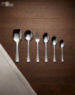 A high-quality 53-piece stainless steel cutlery set arranged elegantly on a dark wood background featuring various spoons, forks, and knives as displayed in 6.jpg.