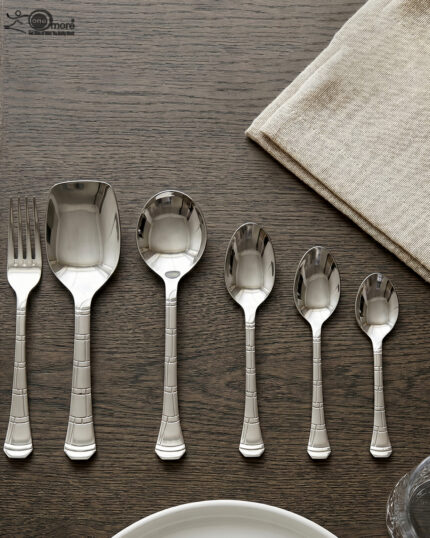 An elegant assortment of stainless steel flatware, including various spoons, forks, and knives arranged on a wooden table as featured in 6.jpg, representing a complete 53-piece dining set.