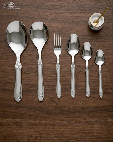 High-quality stainless steel cutlery set featuring table spoons, tea spoons, forks, and serving utensils arranged on a dark wooden background, as displayed in 7.jpg.