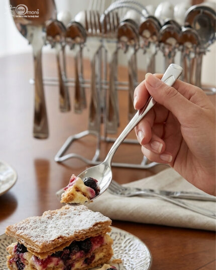 Professional studio photography showing the high-quality finish of the 53-piece stainless steel cutlery set arranged on a wooden surface, as displayed in 8.jpg.