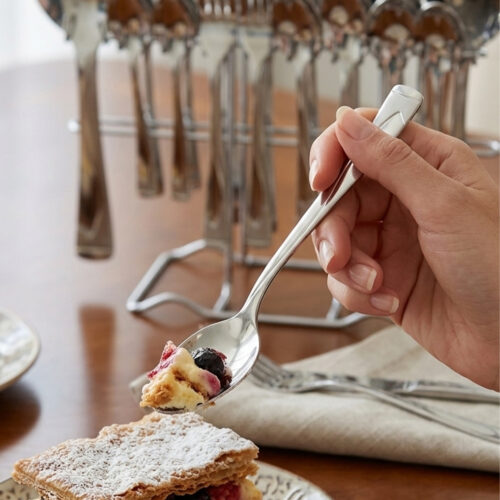 Professional studio photography showing the high-quality finish of the 53-piece stainless steel cutlery set arranged on a wooden surface, as displayed in 8.jpg.