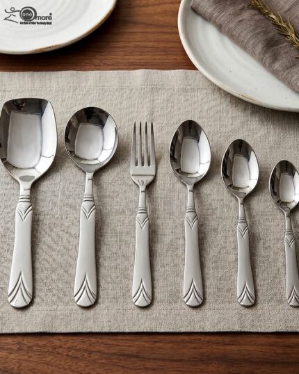 A complete 37-piece stainless steel cutlery set, including various spoons, forks, and knives with decorative handles, displayed on a linen tablecloth as shown in 7.jpg.