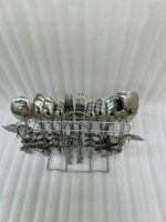 A high-quality 53-piece stainless steel cutlery set featuring elegant patterned handles, displayed on a grey fabric surface as shown in 9.jpg.
