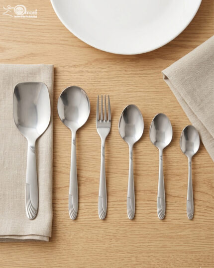 A high-angle view of a complete 53-piece stainless steel cutlery set arranged neatly on a wooden table, as displayed in 7.jpg