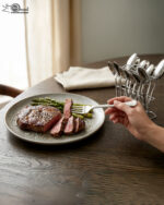 An elegant assortment of stainless steel flatware, including various spoons, forks, and knives arranged on a wooden table as featured in 6.jpg, representing a complete 53-piece dining set.