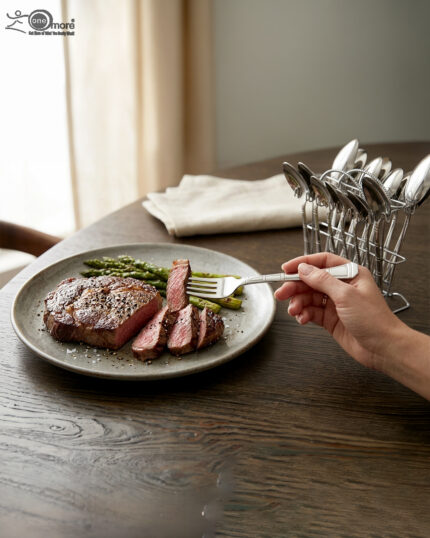 An elegant assortment of stainless steel flatware, including various spoons, forks, and knives arranged on a wooden table as featured in 6.jpg, representing a complete 53-piece dining set.