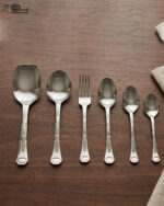 A complete 53-piece stainless steel dining cutlery set featuring spoons, forks, knives, and a serving stand displayed elegantly on a wooden background, as featured in 8.jpg.