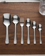 Professional studio photography showing the high-quality finish of the 53-piece stainless steel cutlery set arranged on a wooden surface, as displayed in 8.jpg.