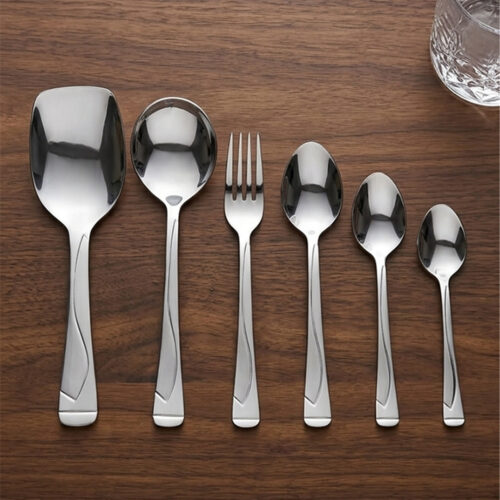 Professional studio photography showing the high-quality finish of the 53-piece stainless steel cutlery set arranged on a wooden surface, as displayed in 8.jpg.