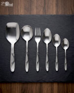 Elevate your dining table with this complete 53-piece cutlery set, expertly crafted to combine durability with timeless elegance. Made from high-quality stainless steel, this set is designed to resist tarnish and rust, ensuring your utensils maintain their shine for years to come. Whether you are hosting a formal dinner or upgrading your daily dining experience, this versatile set provides everything you need for service, organization, and style. Key Features Comprehensive 53-Piece Set: Includes everything required for a full table setting, neatly organized with an included stand for convenient storage and display. Premium Quality Material: Crafted from durable, corrosion-resistant stainless steel. Proudly Made in Pakistan: Supports local craftsmanship with high-grade manufacturing standards. Versatile Collection: Designed to handle every course, from soups and rice to main entrees. Set Breakdown: 12 x Table Spoons 12 x Tea Spoons 12 x Forks 12 x Knives 2 x Rice Serving Spoons 2 x Soup Serving Spoons 1 x Cutlery Stand