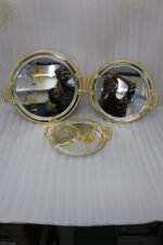 A luxury 3-piece round stainless steel serving tray set with gold textured handles and etched gold floral designs, arranged on a marble kitchen countertop as shown in 1.jpg.