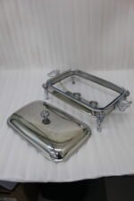 One More 3-liter premium stainless steel rectangular chafing dish with ornate legs and dual buffet burners on a luxury dining table setup.