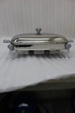 One More 3-liter premium stainless steel rectangular chafing dish with ornate legs and dual buffet burners on a luxury dining table setup.