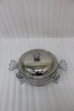 Premium 2-liter glass chafing dish with an ornate silver stand, dome lid, and integrated buffet burner holder on a wooden dining table, branded by One More.