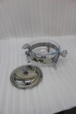 Premium 2-liter glass chafing dish with an ornate silver stand, dome lid, and integrated buffet burner holder on a wooden dining table, branded by One More.