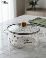 Alt Text: One More 2.5L square glass pot with floral prints, clear glass lid, and a wooden knob resting on a marble countertop.