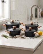 Set of four premium Turkish diamond-infused non-stick pots in sizes 20cm, 22cm, 24cm, and 26cm displayed on a kitchen counter, available at OneMore Pakistan.