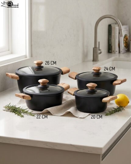 Set of four premium Turkish diamond-infused non-stick pots in sizes 20cm, 22cm, 24cm, and 26cm displayed on a kitchen counter, available at OneMore Pakistan.