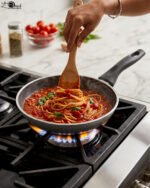 Three sizes of grey diamond-infused non-stick frying pans (20cm, 22cm, 26cm) arranged on a kitchen counter.