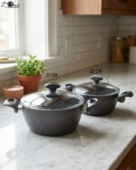 A pair of premium diamond-infused non-stick cooking pots in 20cm and 22cm sizes, made in Turkey, displayed on a marble kitchen countertop.
