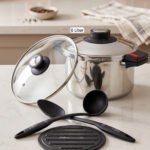 Falez 6L non-stick stainless steel 6-piece cooker set featuring a pot, lid, two spoons, and a heat-resistant table pad on a countertop.