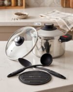 Falez 6L non-stick stainless steel 6-piece cooker set featuring a pot, lid, two spoons, and a heat-resistant table pad on a countertop.