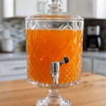 Elegant 4.5 liter glass beverage dispenser featuring a diamond-cut pattern and metal spigot on a table, as seen in 2.jpg.