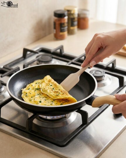 A collection of Turkish-made diamond-infused non-stick frying pans in various sizes ranging from 20cm to 30cm, displayed on a kitchen wall and countertop at OneMore.